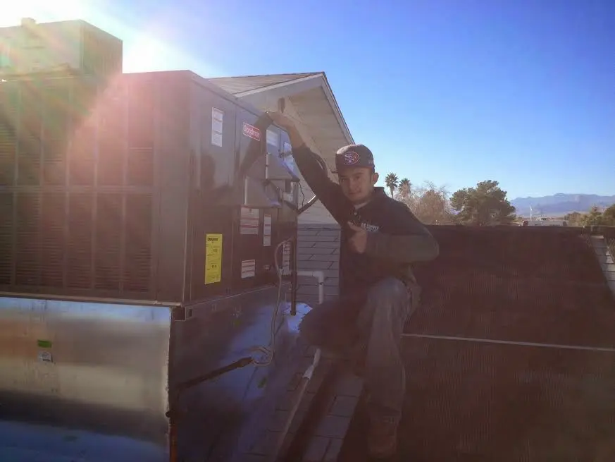 HVAC technician performing Boiler Repair on a rooftop unit in Steilacoom